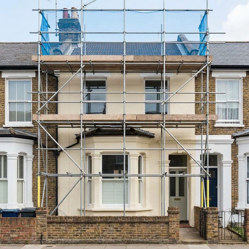 London house frontage under a full access scaffold for painting and render